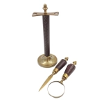 Brass paper knife and magnifying glass on a stand in a leather frame