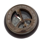 Brass compass and sundial on wooden base