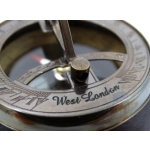 Brass compass and sundial on wooden base