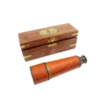 A brass and leather bezel in a wooden box