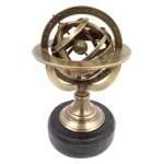 Brass astrolabe on a black stone base