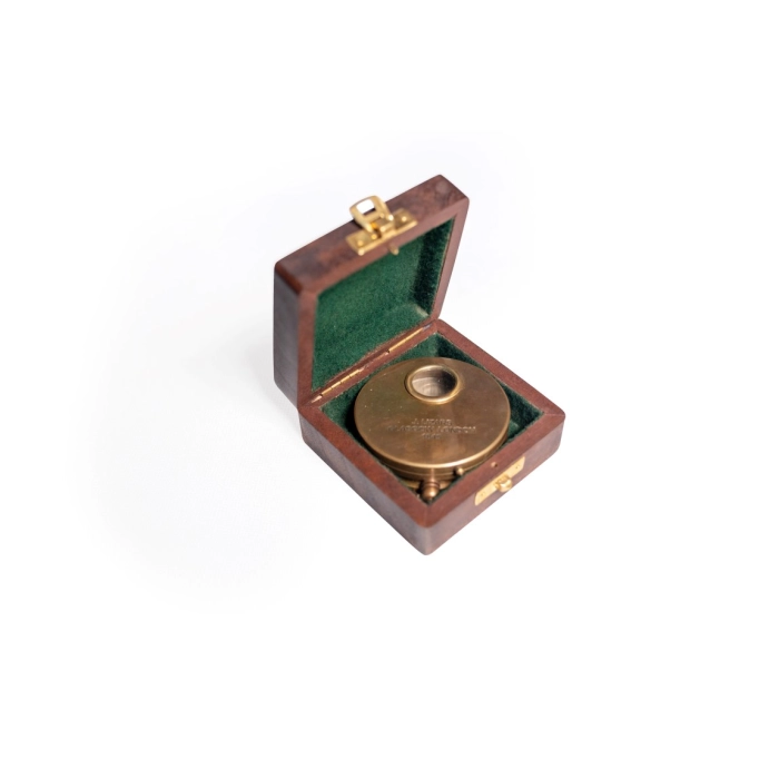 Brass compass in wooden box