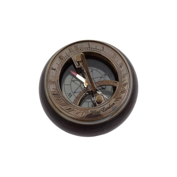Brass compass and sundial on wooden base
