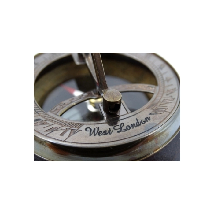 Brass compass and sundial on wooden base