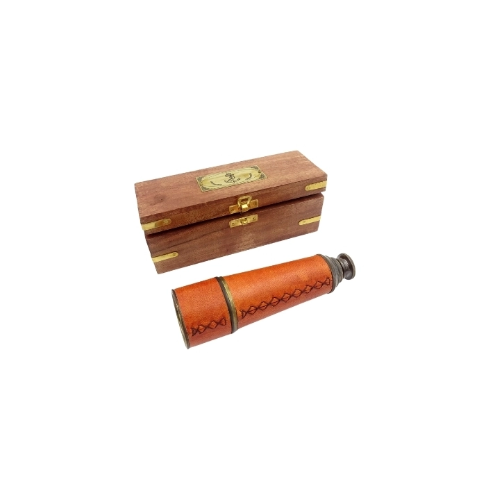 A brass and leather bezel in a wooden box