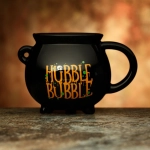 A ceramic cup of a witch's cauldron